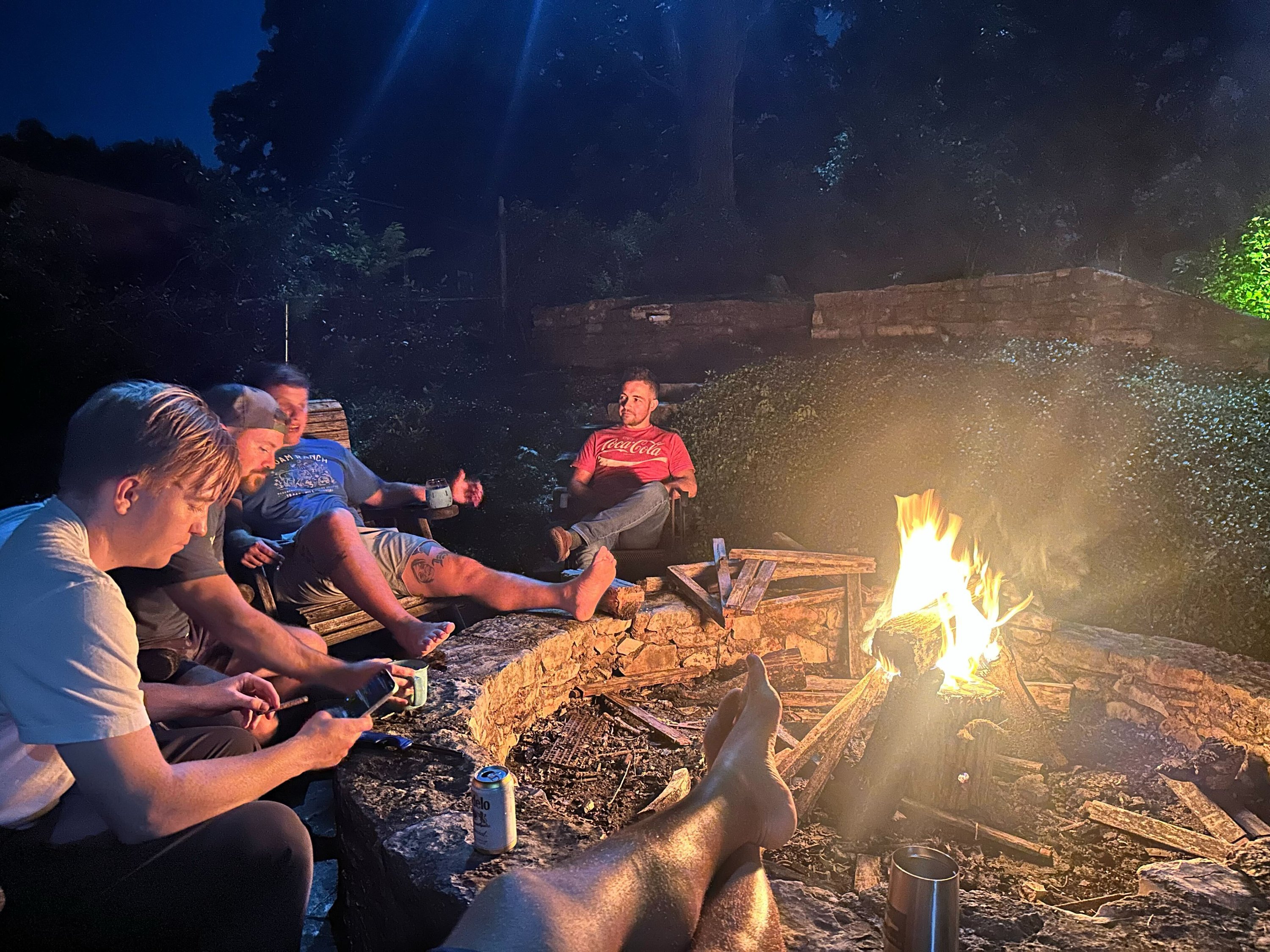 Brotherhood men around a campfire on retreat